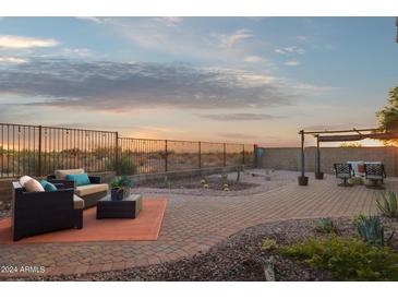 Expansive back patio with desert landscaping, wrought iron fence and comfortable seating, perfect for outdoor living at 10109 E Trailhead Ct, Gold Canyon, AZ 85118