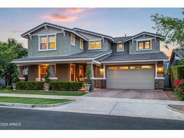 Beautiful two-story home featuring a manicured lawn and a spacious two-car garage at 10344 E Trillium Ave, Mesa, AZ 85212