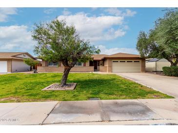 Charming single-story brick home featuring a well-maintained lawn and an attached two-car garage at 1062 E Watson Dr, Tempe, AZ 85283