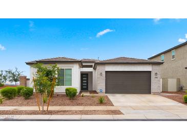 Beautiful single-story home featuring a two-car garage and nicely landscaped front yard at 14587 W Alexandria Way, Surprise, AZ 85379