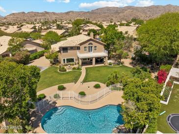 Aerial view of home's spacious backyard, featuring a pool, lush landscaping, and a balcony overlooking the yard at 14655 S 25Th Way, Phoenix, AZ 85048