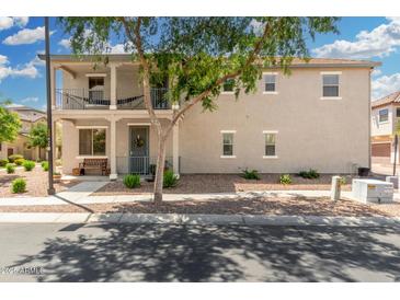 Inviting two-story home with charming balcony and well-maintained front yard landscaping at 1689 E Elgin St, Gilbert, AZ 85295