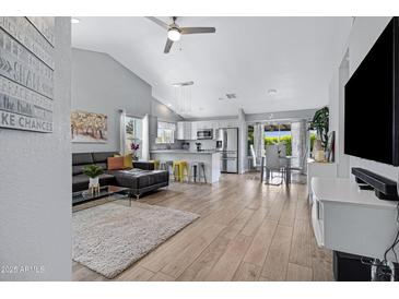 Open-concept living and dining area with modern furnishings and abundant natural light at 20822 N 34Th Dr, Phoenix, AZ 85027
