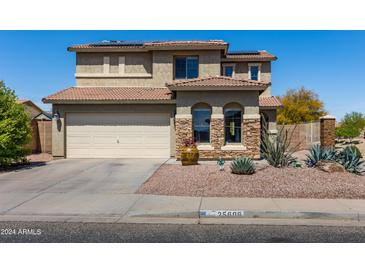 Inviting two-story home featuring a tile roof, desert landscaping, and a two-car garage at 25606 W Satellite Ln, Buckeye, AZ 85326