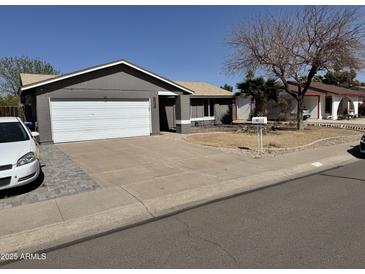 Single-story home featuring a two-car garage, neutral paint, and a well-maintained front yard on a sunny day at 822 W El Alba Way, Chandler, AZ 85225