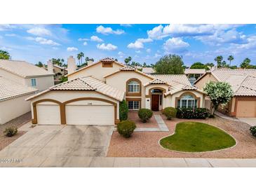 Charming home showcasing a well-manicured front yard and an attached two-car garage with desert landscaping at 1146 W Sea Fog Dr, Gilbert, AZ 85233