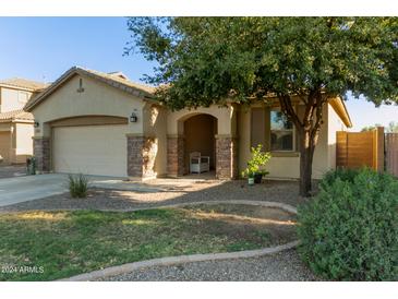 Charming single-story home featuring stone accents, a two-car garage, and desert landscaping in a sunny neighborhood at 1277 W Stephanie Ln, San Tan Valley, AZ 85143