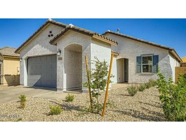 Charming single-story home featuring stucco siding, gray garage door, and low-maintenance desert landscaping at 16754 W Alameda Rd, Surprise, AZ 85387