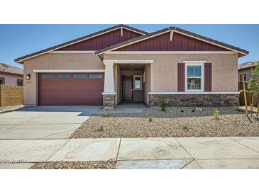 Charming single-story home featuring a two-car garage and low-maintenance desert landscaping at 16781 W Bronco Trl, Surprise, AZ 85387