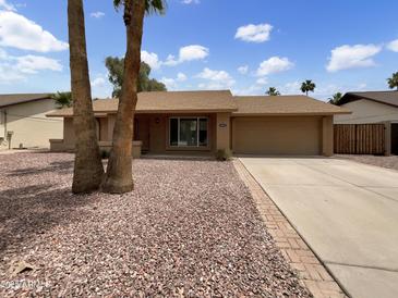 Charming single-story home with a well-maintained yard and a spacious two-car garage at 1913 N Verano Way, Chandler, AZ 85224