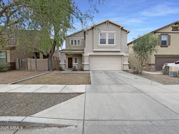Inviting two-story home with a wide driveway, attached garage, and well-maintained lawn at 4005 W Carter Rd, Phoenix, AZ 85041
