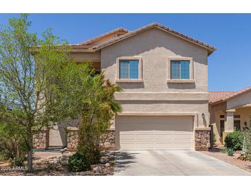 Charming two-story home featuring a well-maintained front yard and attached two-car garage at 44810 W Horse Mesa Rd, Maricopa, AZ 85139