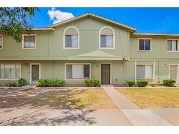 Charming townhome with a well-maintained lawn and classic architectural details at 4743 N 26Th Ln, Phoenix, AZ 85017