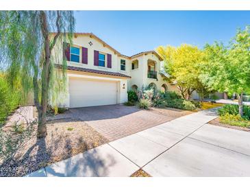 Charming two-story home boasts a two-car garage, landscaped yard, and inviting curb appeal at 4836 S Covalent Ln, Mesa, AZ 85212