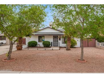 Charming home featuring a well-maintained front yard with mature trees at 5025 N 20Th Ave, Phoenix, AZ 85015