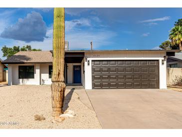 Charming home featuring a two-car garage, xeriscaped yard, and a lovely Saguaro cactus at 7125 N 23Rd Ave, Phoenix, AZ 85021