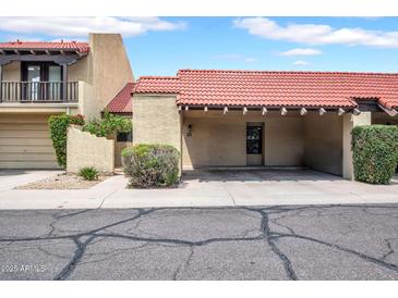 Charming townhome with a red tile roof, covered parking, and desert landscaping at 10235 N 31St St # 15, Phoenix, AZ 85028
