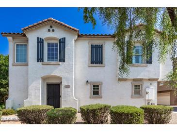 Charming two-story home featuring a stucco exterior, decorative shutters, and a tile roof at 4243 E Jasper Dr, Gilbert, AZ 85296