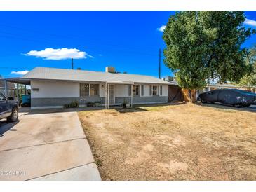Charming single-story home with a well-maintained yard and a cozy, inviting front porch at 4828 N 71St Ave, Phoenix, AZ 85033