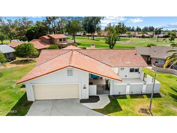 Aerial view of a well-maintained single-story home with a red tile roof and attached two-car garage at 633 Leisure World --, Mesa, AZ 85206