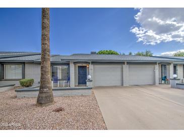 Charming single-story home with a well-maintained front yard and a two-car garage at 7950 E Keats Ave # 175, Mesa, AZ 85209