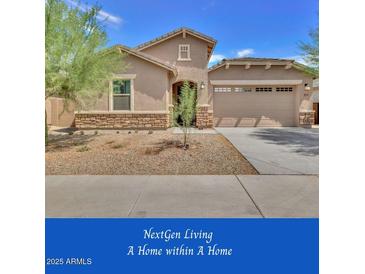 Charming single-story home features a two-car garage and a low-maintenance desert landscape at 9630 W Atlantis Way, Tolleson, AZ 85353