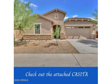 Charming single-story home featuring a two-car garage and a low-maintenance front yard at 9630 W Atlantis Way, Tolleson, AZ 85353