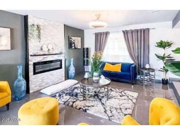 Charming living room features a modern fireplace, stylish decor, and bright, inviting light at 11215 N 37Th Ave, Phoenix, AZ 85029