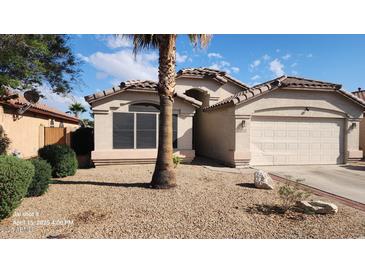 Charming single-story home with desert landscaping, a tile roof, and an attached two-car garage at 15329 W Melissa Ln, Surprise, AZ 85374