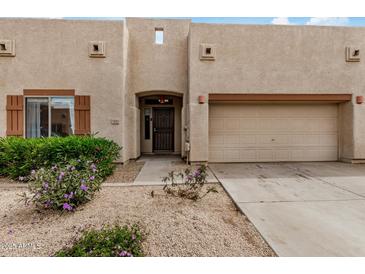 Charming home featuring an attached two-car garage and low maintenance desert landscaping at 1650 S Crismon Rd # 13, Mesa, AZ 85209