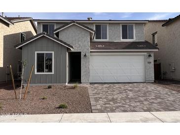 Charming two-story home featuring a two-car garage and neutral stucco finish at 18183 W Larkspur Dr, Goodyear, AZ 85338