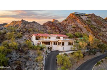 Luxury hillside home with red tile roof and long driveway winding through desert landscape at 1836 E Turquoise Ave, Phoenix, AZ 85020
