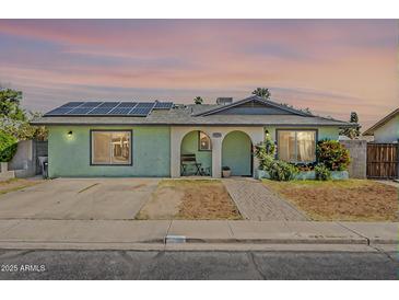 Charming single-story home featuring solar panels, an arched entryway and desert-friendly landscaping at 1838 E 2Nd Pl, Mesa, AZ 85203