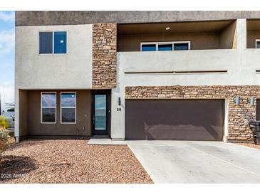 Modern two-story home with a stone facade, private balcony, and low-maintenance desert landscaping at 2000 N 36Th St # 29, Phoenix, AZ 85008