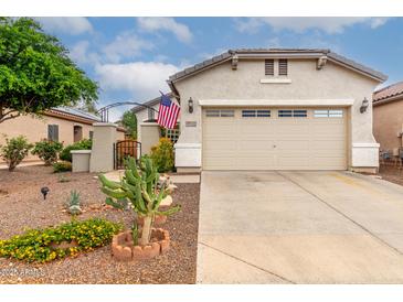 Charming single-Gathering home featuring a two-car garage and a beautifully landscaped front yard at 26145 W Runion Dr, Buckeye, AZ 85396