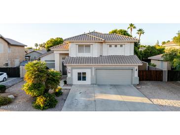 Charming two-story home with a well-manicured lawn, a two-car garage, and a welcoming entrance at 288 W Los Alamos St, Gilbert, AZ 85233