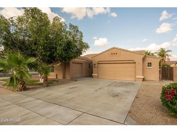 Charming single-story home featuring a well-manicured front yard, spacious driveway, and a two-car garage at 3047 S Chatsworth --, Mesa, AZ 85212
