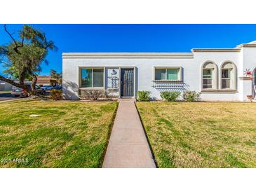 Charming single-story home with well-maintained lawn and walkway at 5047 N 83Rd St, Scottsdale, AZ 85250