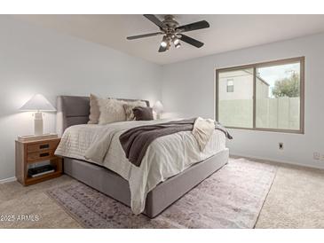 Comfortable bedroom features a cozy bed with plush bedding and a ceiling fan at 5052 W Boston S Way, Chandler, AZ 85226