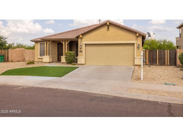Inviting single-story home featuring a well-kept front yard and attached two car garage at 517 S 165Th Dr, Goodyear, AZ 85338
