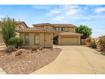 Charming two-story home featuring a well-manicured yard and a spacious driveway leading to a two-car garage at 6245 W Maya Dr, Phoenix, AZ 85083