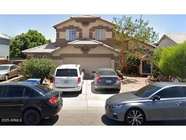 Charming two-story home with a well-maintained front yard and a two car garage at 8543 W Wilshire Dr, Phoenix, AZ 85037