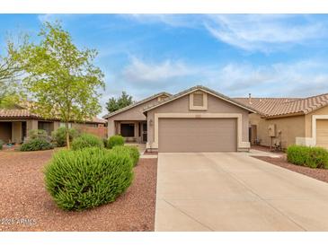 Charming single-story home with a two-car garage, landscaped front yard, and a well-maintained lawn at 11410 W Davis Ln, Avondale, AZ 85323