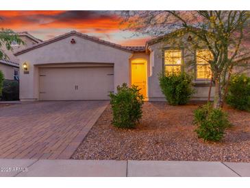 Charming single-story home featuring a two-car garage and attractive desert landscaping at 13720 W Amberwing St, Peoria, AZ 85383