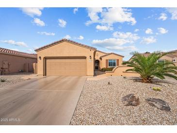 Charming single-story home featuring a well-maintained front yard with desert landscaping and an attached two-car garage at 16444 W Chuparosa Ln, Surprise, AZ 85387