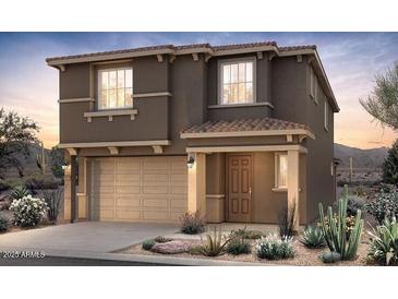 A charming two-story home featuring desert landscaping, a two-car garage and an inviting entryway at 17601 W Luke Ave, Litchfield Park, AZ 85340