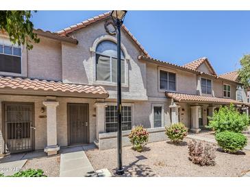 Charming townhome with a well-maintained front yard and covered entry, offering curb appeal at 1961 N Hartford St # 1055, Chandler, AZ 85225