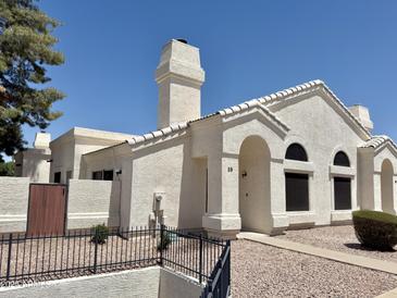 Charming single-story home featuring a stucco exterior, arched entryway, and well-maintained landscaping at 2100 W Lemon Tree Pl # 59, Chandler, AZ 85224