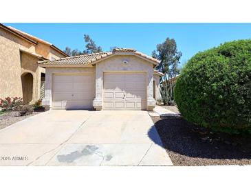 Charming home featuring a two-car garage, desert landscaping, and a well-maintained front yard at 3122 E Kristal Way, Phoenix, AZ 85050