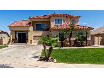 Stunning two-story home with tile roof, lush landscaping, and an attached two-car garage at 3644 E Del Rio St, Gilbert, AZ 85295